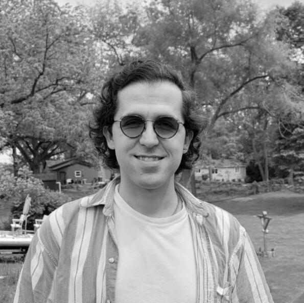 a black and white portrait of myself in flannel and a cardigan on an invitingly brisk fall afternoon
